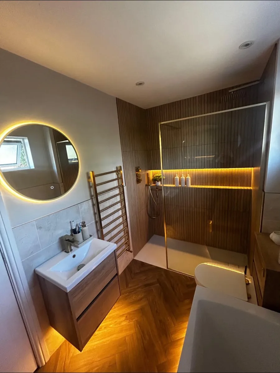 Bathroom with walk-in shower, lit niche and herringbone floor, fitted by TF Heating